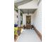 Charming front porch with a wooden door, decorative wreath, potted flowers, and classic brick detailing at 1753 Russell Se St, Atlanta, GA 30316