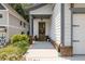 Inviting front porch features a wooden door, decorative wreath, potted plants, and charming brick accents at 1753 Russell Se St, Atlanta, GA 30316