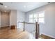 Bright hallway with hardwood floors, white trim, and a large window that provides ample natural light at 1753 Russell Se St, Atlanta, GA 30316
