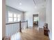 Bright hallway featuring hardwood floors, white railings, and a glimpse of the bedroom at 1753 Russell Se St, Atlanta, GA 30316