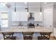 Bright kitchen features white cabinets, granite countertops and three pendant lights above the island at 1753 Russell Se St, Atlanta, GA 30316