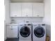 Laundry room featuring white cabinets, counter space, and appliances at 1753 Russell Se St, Atlanta, GA 30316