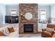 Living room featuring brick fireplace with decor and adjacent television at 1753 Russell Se St, Atlanta, GA 30316
