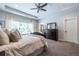 Well-lit main bedroom with neutral tones, a ceiling fan, and a view of the ensuite bathroom at 1753 Russell Se St, Atlanta, GA 30316