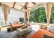 Inviting covered patio with decorative curtains, stone flooring, ceiling fan, and outdoor furniture for relaxation at 1753 Russell Se St, Atlanta, GA 30316