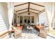 Relaxing covered patio featuring stone flooring, comfortable seating, and elegant curtains for privacy and style at 1753 Russell Se St, Atlanta, GA 30316