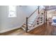 Elegant staircase with white banister, hardwood steps, and built-in bookshelves at 1753 Russell Se St, Atlanta, GA 30316