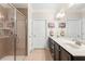 Well-lit bathroom featuring double sinks, a tile shower, and abundant cabinet space at 325 Ridge Hill Cir # 3, Marietta, GA 30064