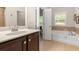 Bathroom featuring a soaking tub with tile surround, vanity with sink, and neutral colors at 325 Ridge Hill Cir # 3, Marietta, GA 30064