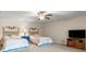 Spacious bedroom featuring two twin beds, ceiling fan, carpet, and a TV on a wooden stand at 325 Ridge Hill Cir # 3, Marietta, GA 30064