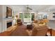 Inviting living room featuring a fireplace, hardwood floors, neutral paint, ceiling fan, and access to a patio at 325 Ridge Hill Cir # 3, Marietta, GA 30064