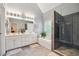 Bright bathroom with a double sink vanity, soaking tub, and walk-in glass shower at 4440 Weston Sw Dr, Lilburn, GA 30047