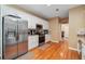 Well-lit kitchen featuring stainless steel appliances, granite countertops, and wooden floors at 4440 Weston Sw Dr, Lilburn, GA 30047
