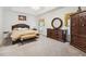 Spacious main bedroom featuring tray ceilings, carpet, and a large dark wood dresser at 4440 Weston Sw Dr, Lilburn, GA 30047