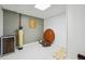 Unfinished basement storage room featuring painted concrete floors, light grey walls, and utility fixtures at 4440 Weston Sw Dr, Lilburn, GA 30047
