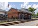 Brick train depot with an American flag, passenger waiting area, and train tracks at 515 Regency Trl, Acworth, GA 30102