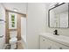 Bright bathroom featuring a toilet, tub-shower, and black faucet vanity at 6201 Davids Se Way, Acworth, GA 30102