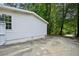 Side view of the house with concrete driveway, white siding and green trees in background at 6201 Davids Se Way, Acworth, GA 30102