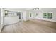 Open-concept living room features sleek vinyl floors, fresh white paint, and abundant natural light at 6201 Davids Se Way, Acworth, GA 30102