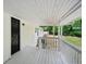 Porch with a black wooden front door and wooden floors at 6201 Davids Se Way, Acworth, GA 30102