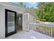 Covered porch overlooking the backyard with a black-framed glass door leading into the home at 6201 Davids Se Way, Acworth, GA 30102