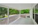 Open porch with wooden floor and white railings, overlooking the green wooded area at 6201 Davids Se Way, Acworth, GA 30102