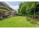 This home features a large, manicured backyard and covered patio area at 1075 Bluffhaven Way Northeast Ne Way, Atlanta, GA 30319
