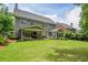 This home features a large, manicured backyard and covered patio area at 1075 Bluffhaven Way Northeast Ne Way, Atlanta, GA 30319