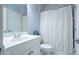 This bathroom features a shower with a curtain, a toilet and a sink with updated fixtures at 1075 Bluffhaven Way Northeast Ne Way, Atlanta, GA 30319