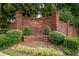 Welcoming brick entrance to The Bluffs of Nancy Creek community amidst lush landscaping and greenery at 1075 Bluffhaven Way Northeast Ne Way, Atlanta, GA 30319