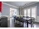 Elegant dining room with modern chandelier, dark wood floors, and views to the living room at 1075 Bluffhaven Way Northeast Ne Way, Atlanta, GA 30319