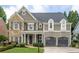Charming home featuring stone and shingle siding, a manicured lawn and an attached two-car garage at 1075 Bluffhaven Way Northeast Ne Way, Atlanta, GA 30319
