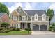 Charming two-story home featuring a stone facade, shingle siding, a two-car garage and manicured landscaping at 1075 Bluffhaven Way Northeast Ne Way, Atlanta, GA 30319
