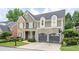 Charming two-story home featuring a stone facade, shingle siding, a two-car garage and manicured landscaping at 1075 Bluffhaven Way Northeast Ne Way, Atlanta, GA 30319