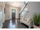 Inviting foyer featuring dark wood floors, a staircase, and a comfortable seating area at 1075 Bluffhaven Way Northeast Ne Way, Atlanta, GA 30319