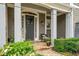 Inviting front entrance features a covered porch with stone accents, columns, and decorative plantings at 1075 Bluffhaven Way Northeast Ne Way, Atlanta, GA 30319