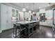 Spacious kitchen with a large island, pendant lighting, stainless steel appliances, and dark hardwood flooring at 1075 Bluffhaven Way Northeast Ne Way, Atlanta, GA 30319