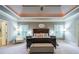 Spacious main bedroom featuring a decorative tray ceiling and sitting area at 1075 Bluffhaven Way Northeast Ne Way, Atlanta, GA 30319