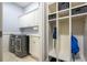 Convenient mud room includes washer, dryer, storage cabinets, and coat rack for organization at 1075 Bluffhaven Way Northeast Ne Way, Atlanta, GA 30319