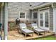 Outdoor kitchen with built-in grill, stone counter, and lounge chairs for relaxation at 1075 Bluffhaven Way Northeast Ne Way, Atlanta, GA 30319
