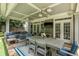 Inviting covered patio with outdoor seating, ceiling fans, and a TV, perfect for entertaining at 1075 Bluffhaven Way Northeast Ne Way, Atlanta, GA 30319
