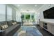 Versatile sun room with multiple windows, plush sofa, and a desk perfect for work or relaxation at 1075 Bluffhaven Way Northeast Ne Way, Atlanta, GA 30319