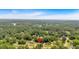 Expansive aerial view of a home nestled amongst mature trees in a quiet neighborhood on a sunny day at 115 Creek Cir, Stockbridge, GA 30281