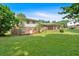Lush backyard with a brick home and a screened in porch at 115 Creek Cir, Stockbridge, GA 30281