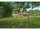 Lush backyard with a glimpse of the home's screened porch at 115 Creek Cir, Stockbridge, GA 30281
