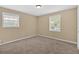 Neutral bedroom featuring two windows providing natural light and plush carpeting at 115 Creek Cir, Stockbridge, GA 30281