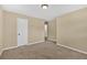 Neutral bedroom featuring plush carpeting and a door leading to other rooms at 115 Creek Cir, Stockbridge, GA 30281