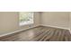 Bedroom with neutral paint, a large window, and modern vinyl plank flooring, creating a bright and airy atmosphere at 115 Creek Cir, Stockbridge, GA 30281