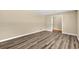 Bedroom with neutral paint, a doorway, and modern vinyl plank flooring, creating a bright and airy atmosphere at 115 Creek Cir, Stockbridge, GA 30281