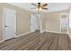 Spacious bedroom with ceiling fan, wood-look flooring, and ensuite bathroom access at 115 Creek Cir, Stockbridge, GA 30281